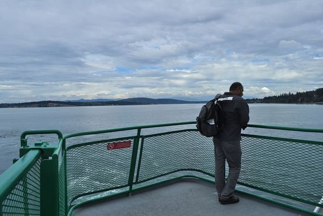 A passenger on the deck of the Washington State ferry on the Anacortes to Sidney run