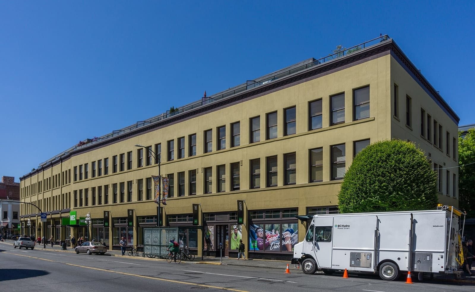 A long three-storey building with shops along Government Street in downtown Victoria